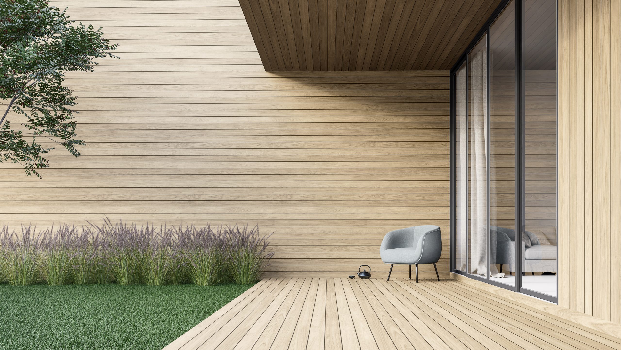 Die Holzdielen auf einer Terrasse können durch einen Outdoor Teppich geschont werden. Foto: © onzon / stock adobe